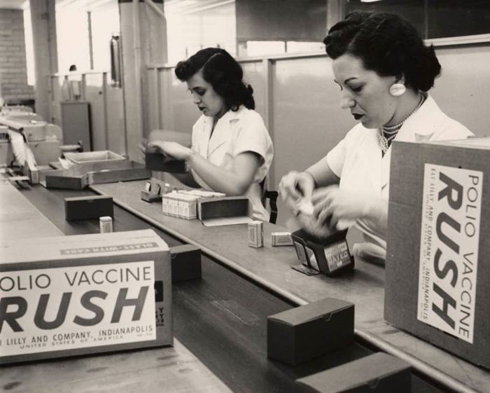Two women pack cartons stamped Polio Vaccine Rush.