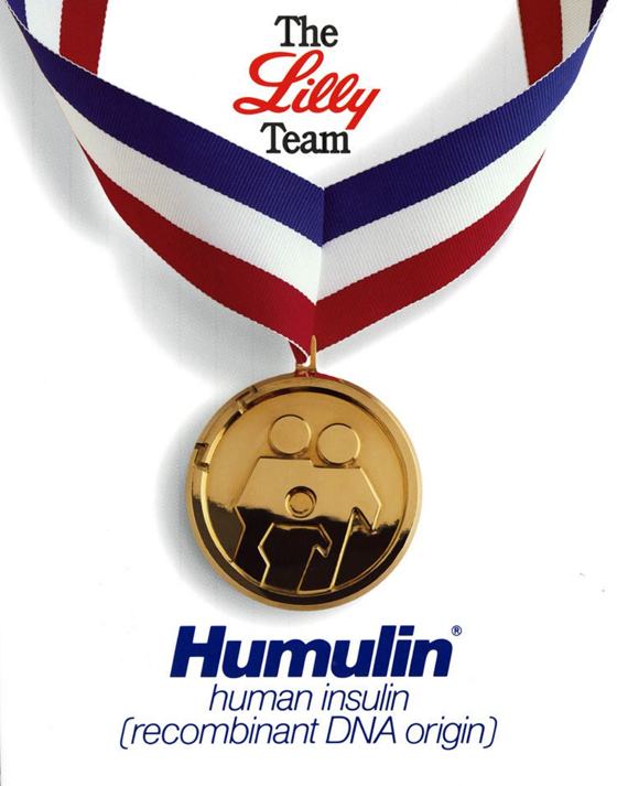 A Humulin advertisement showing a gold medal on a ribbon labelled The Lilly Team.